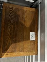 Top-down view of the wooden desk top showing the wood grain pattern and edges.