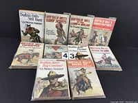 Photo showing 10 vintage Buffalo Bill paperback books by Col. Prentiss Ingraham arranged in two rows with illustrated Western-themed covers.