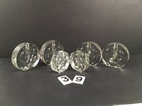 Set of 6 heavy textured clear glass soliflour stem vases arranged in a row against a dark background, showing bubble-like internal texture and thickness.