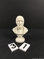 Front view of Hippocrates bust statue with identification markers, highlighting facial details and pedestal.
