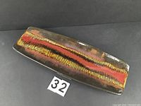 Full view of the rectangular MCM vintage tray showing vibrant iridescent stripes in red, orange, and gold colors across the surface