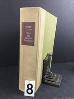 Front view of the Rare and Unusual Canadiana book, showing the beige spine with a brown title label and green cover.