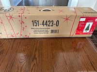 Long rectangular cardboard box with product number 151-4423-0, suitable for shipping or storage of the Christmas tree.