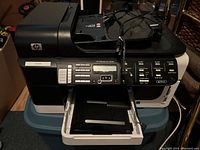 Front and top view of HP OfficeJet Pro 8500 printer showing control panel, paper tray, and output area.