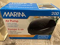 Marina 200 Air Pump boxed, showing product name and key features like quiet running, powerful airflow, double output.