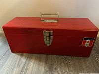 Closed red metal toolbox with handle and Mastercraft label.