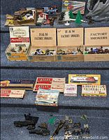 Overview of train accessories including boxed and loose items on carpeted floor