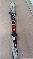 Top side of one Rossignol Junior ski showing branding and bindings.