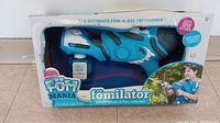 Blue Foam Mania Fomilator foam water gun in original branded packaging showing product features and usage photo.