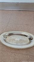 Top view of medium oval silver tray showing engraved detailing and beaded border