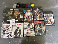 Photo showing all 9 PS2 games and 7 memory cards arranged on the floor, titles legible, items visibly complete with cases.
