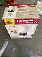 Photo of the original box for the Hamilton Beach Aroma Express coffee maker, showing branding, product image, capacity and model details.