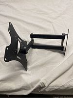 Side view of black adjustable monitor mount arm showing articulating joints and mounting plate