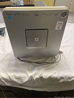 Front view of the silver Sharp FPR30CX air purifier showing control panel and power cord.