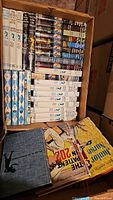 Box of vintage Nancy Drew hardcover books featuring original 1960s dust jackets and covers, neatly arranged.
