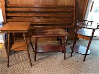 Shows three wood side tables: square, rectangular, and oval shape together on carpet.