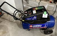 Side view of Campbell Hausfeld air compressor showing tank, wheels and handle