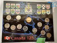 Top view of unopened coin set showing full display with Canadian map background and provincial crests, coins clearly visible.