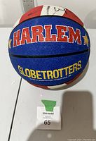 View of the Harlem Globetrotters basketball front panel showing the team name in large letters across the red, white, and blue design.