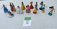 Full view of all 12 Disney Princess figurines lined up in a row showing size and detail
