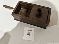 Top view photo of the wooden vintage secret voting box showing compartments and handle.