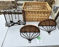 Overall view showing wicker basket, two wooden shelves with black metal mounting brackets, and decorative black metal utensil holder.