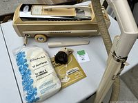 Top-down view of main canister body with accessories laid out