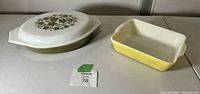 Both casseroles side by side on table with lot tag