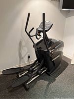 Angled front-left view of elliptical showing frame, pedals, handlebars and console