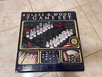 Front of the unopened box showing the chess pieces on the glass board and logos.