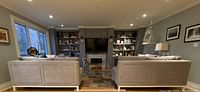 Two grey sofas facing each other in living room across coffee table