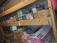 Two large wooden shelves filled with various canning jars and supplies including baskets and boxes.