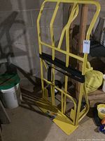 Full view of the yellow moving cart showing steel frame and support bars