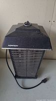 Side view of the 17-inch black Flowtron electric bug zapper showing front mesh, power cord, and brand name.