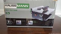 Box of the Haussmann 7-inch wet tile saw showing brand and product details.