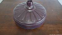 Top angled view of the resin umbrella base showing round shape and ridged design.