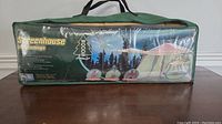 Packing bag with printed graphics including brand Woods, product name Screenhouse with Awning, and features.