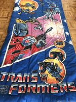 Side view focusing on characters and some visible small holes and light marks on the fabric.