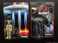 Two Reaction Figures: Alien sealed on card, and The Fifth Element Mangalore figure with detached plastic bubble on card.
