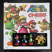 Box cover showing front with select Mario chess figurines visible through window
