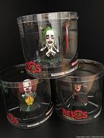 Photo showing all three Revos horror figurines (Chucky, Pennywise, Freddy Krueger) in sealed packaging stacked with Pennywise and Freddy at bottom and Chucky on top