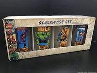 Front view of the glassware set box showing 4 glasses with Marvel characters Spider-Man, Hulk, Thor, and Magneto