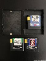 Top view showing NHL 95 cartridge in case open with PGA European Tour and John Madden 93 cartridges below.