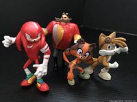 Four mini PVC Sonic The Hedgehog figures displayed: Knuckles, Dr. Robotnik, Tails, and one orange character.