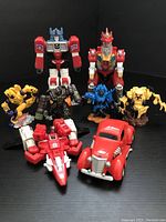 Front view of seven figures including robots, robot animals, and vehicle forms showing colors and details.