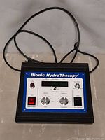 Front view of Bionic Hydro Therapy control unit showing power switches, time and polarity dials, digital display, and ion power controls
