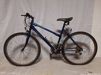 Full left side view of the blue Cascade Ridge F.S. Elite mountain bike showing frame, tires, drivetrain, saddle, and handlebar.