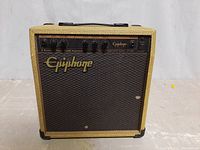Front view showing woven fabric covering, speaker grille with Epiphone logo, control knobs on top front.