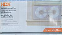 Photo of the box showing HDX Twin Window Fan branding, dimensions and features like 2-1/4 x 12-1/2 in twin fans, 3 speed settings, and extension range up to 17.7 in.