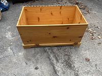 Photo of the pine wood blanket box without the lid showing the natural wood grain and interior space.